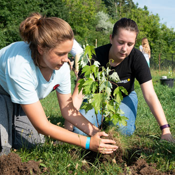 two students gardening