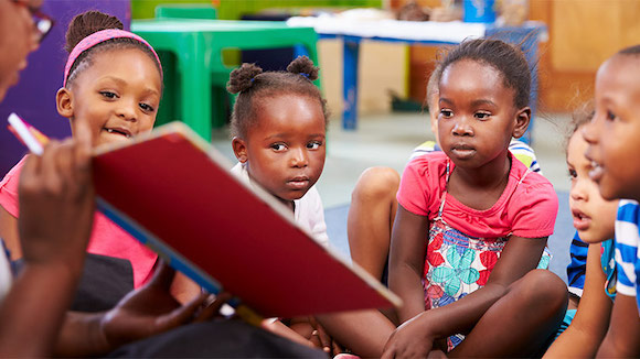 Elementary students being read a story