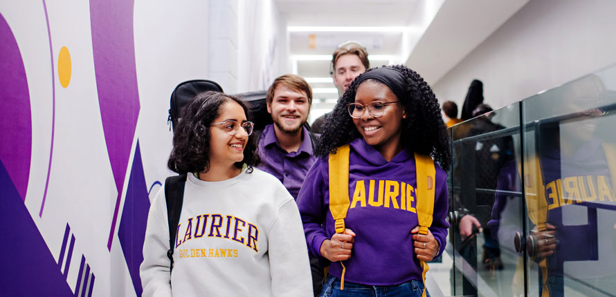 group of students walking in Music hallway with Laurier gear on