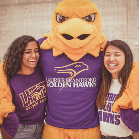 Laurier students with Golden Hawk mascot, Midas