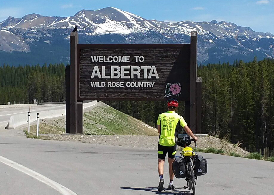 Ryan Martin walks his bike in Alberta