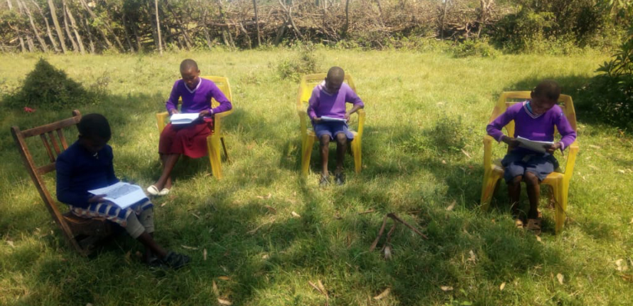 Students reading on chairs in Kenya