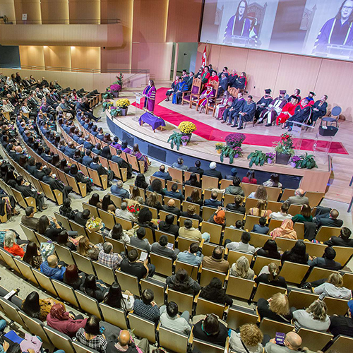 People sitting an auditorium during a convocation ceremony.