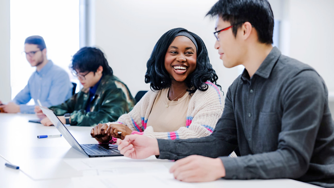 MABE female and male student discussing in class
